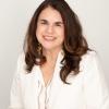 Headshot of Dr. Ornelas with brown hair and wearing a white jacket and gold earrings